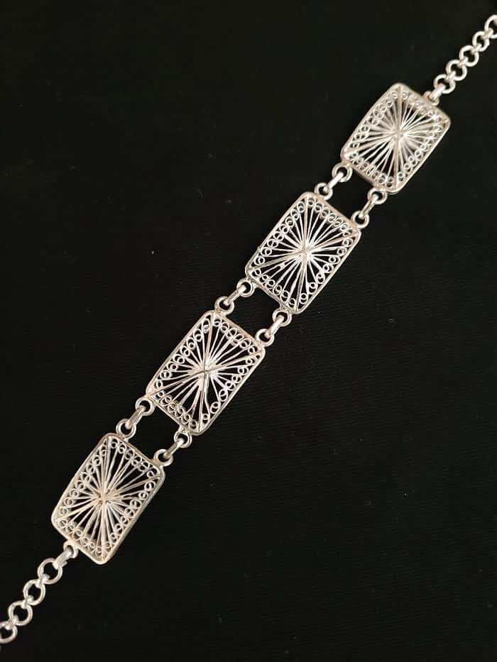 
                      
                        Discover the captivating "Entangled Elegance" silver filigree bracelet
                      
                    