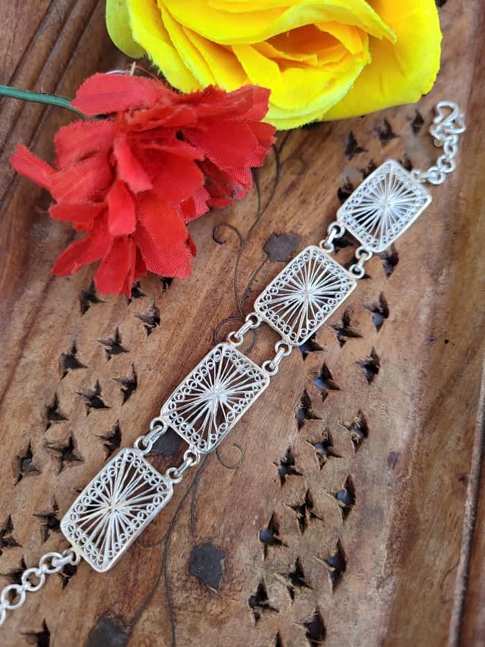 
                      
                        Handmade silver bracelet with intricate web pattern
                      
                    